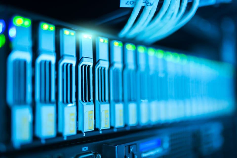 Server rack with network cables lit in blue