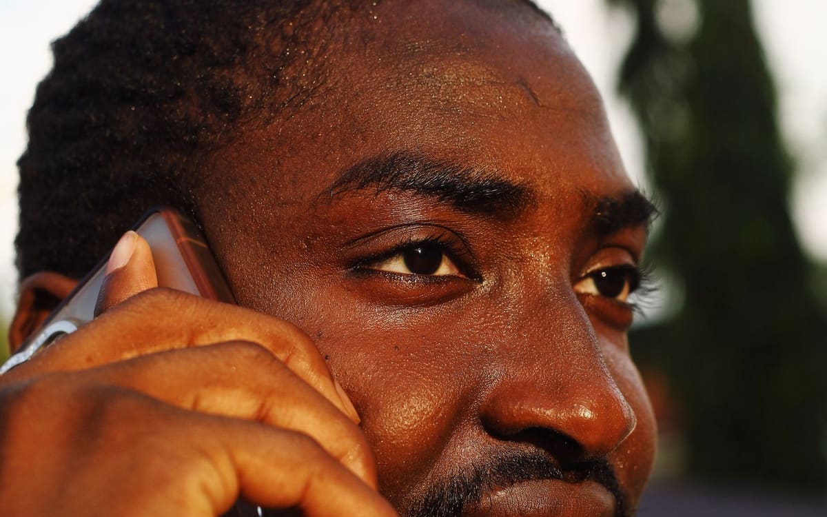Man in Abuja, Nigeria, talking on a mobile phone